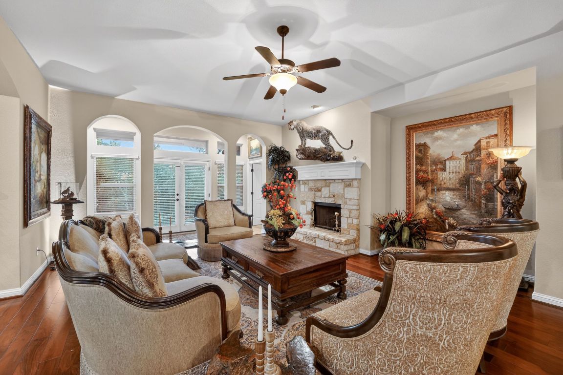 a living room with fireplace furniture and a large window