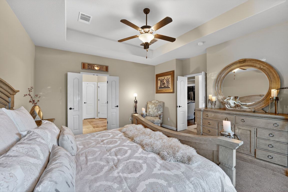 4521 Pyrenees Pass Bee Cave, TX 78738 - Photo 11 of 22 a bedroom with a large bed and closet