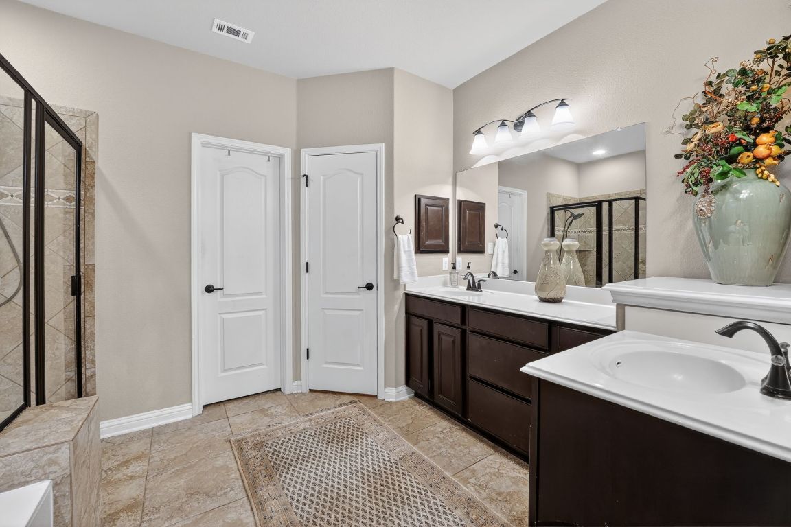4521 Pyrenees Pass Bee Cave, TX 78738 - Photo 13 of 22 a spacious bathroom with a double vanity sink mirror and