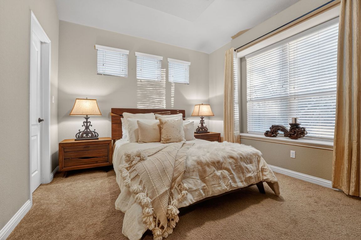 4521 Pyrenees Pass Bee Cave, TX 78738 - Photo 15 of 22 a bed room with a bed and a lamp