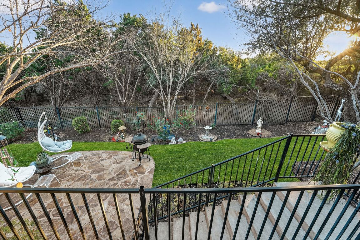 4521 Pyrenees Pass Bee Cave, TX 78738 - Photo 21 of 22 a view of a backyard with a garden