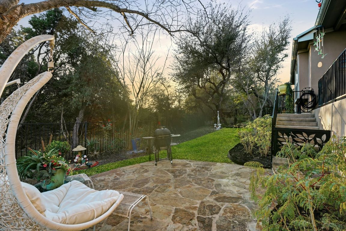 4521 Pyrenees Pass Bee Cave, TX 78738 - Photo 22 of 22 a view of a backyard with plants and a fountain