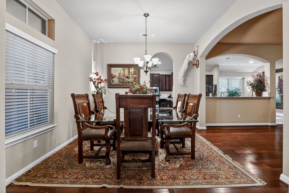 4521 Pyrenees Pass Bee Cave, TX 78738 - Photo 5 of 22 a view of a dining room with furniture and wooden floor