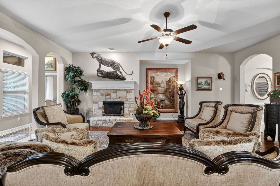 4521 Pyrenees Pass Bee Cave, TX 78738 - Photo 10 of 22 a living room with furniture a fireplace and window