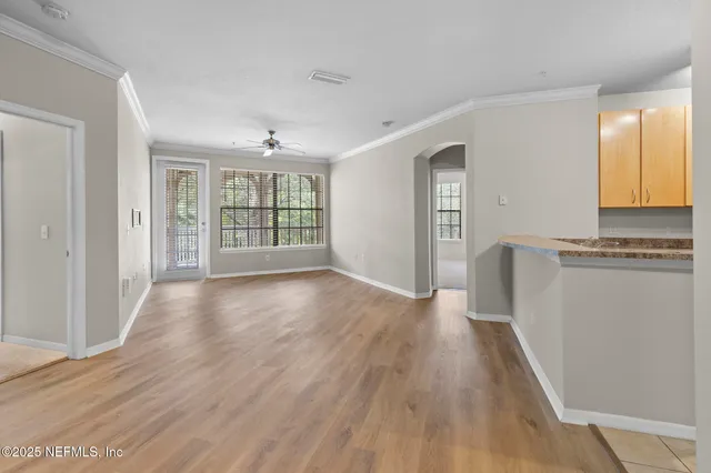 wooden floor in an empty room with a window