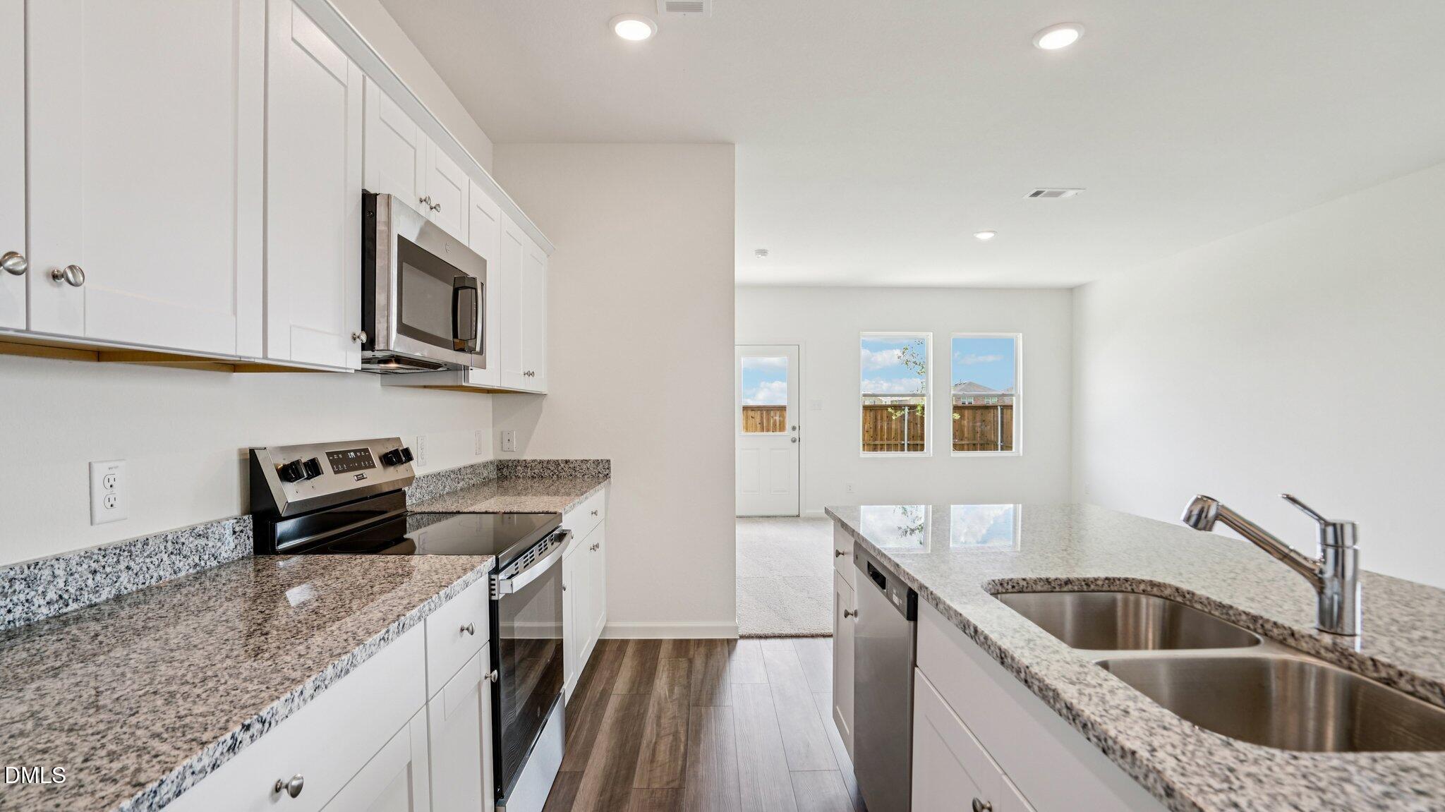 1304 Solace Way Rolesville, NC 27571 - Photo 12 of 34 a kitchen that has a sink and a stove