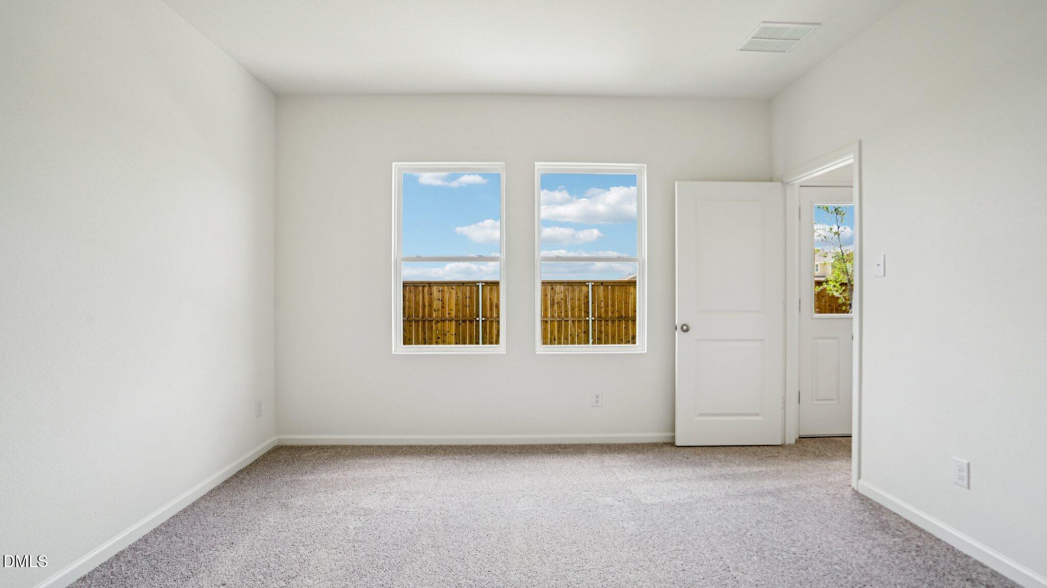1304 Solace Way Rolesville, NC 27571 - Photo 19 of 34 an empty room with windows