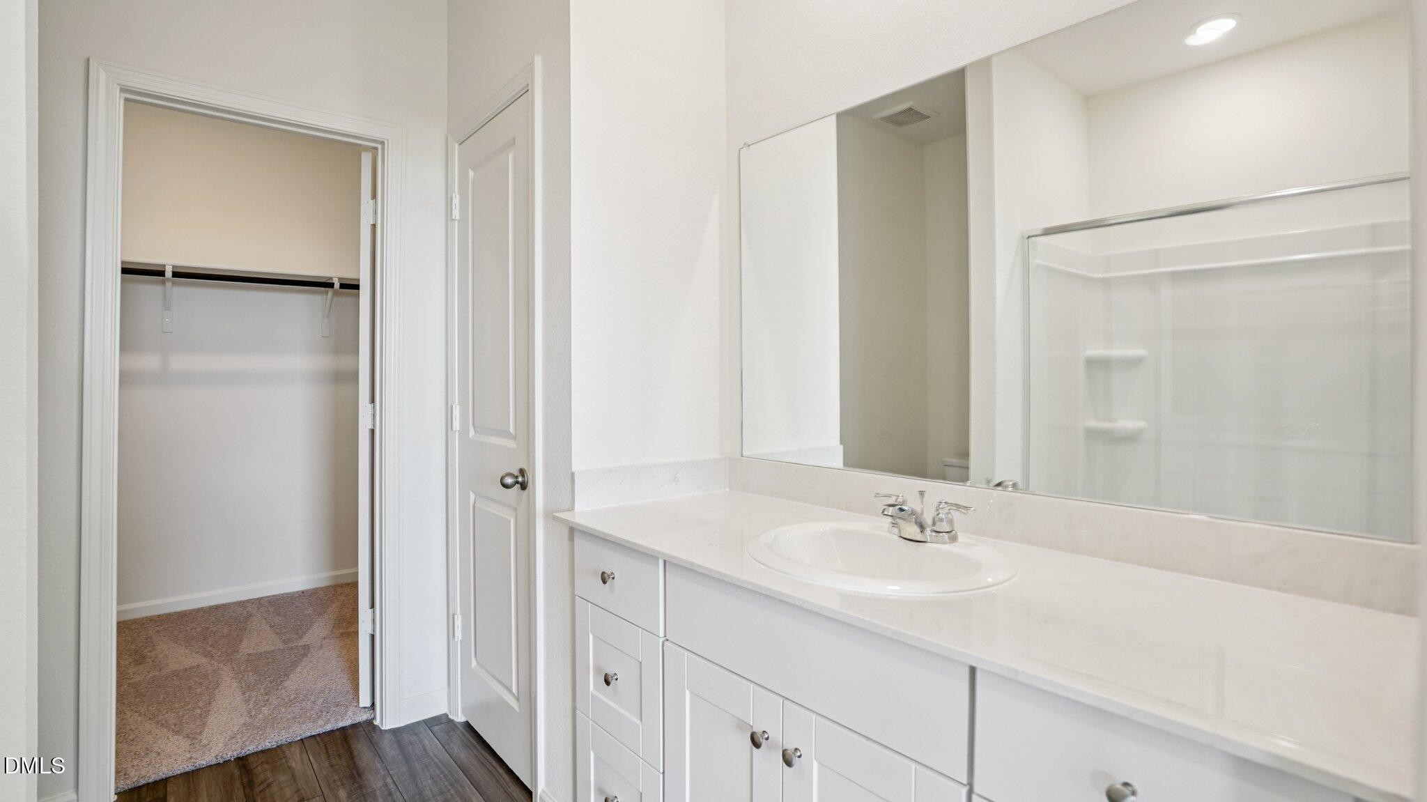 1304 Solace Way Rolesville, NC 27571 - Photo 20 of 34 a bathroom with a shower sink and mirror