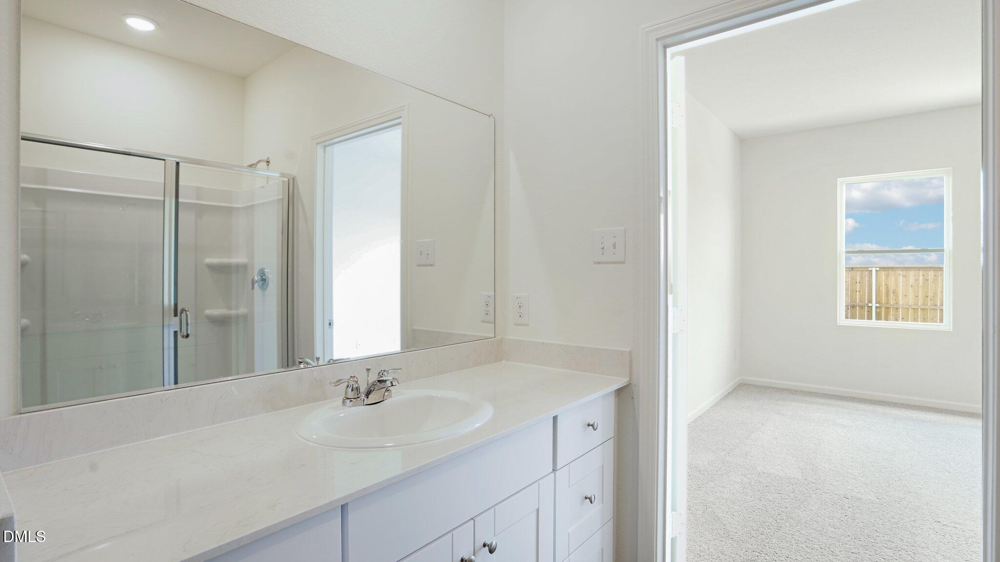 1304 Solace Way Rolesville, NC 27571 - Photo 21 of 34 a bathroom with a sink and a mirror
