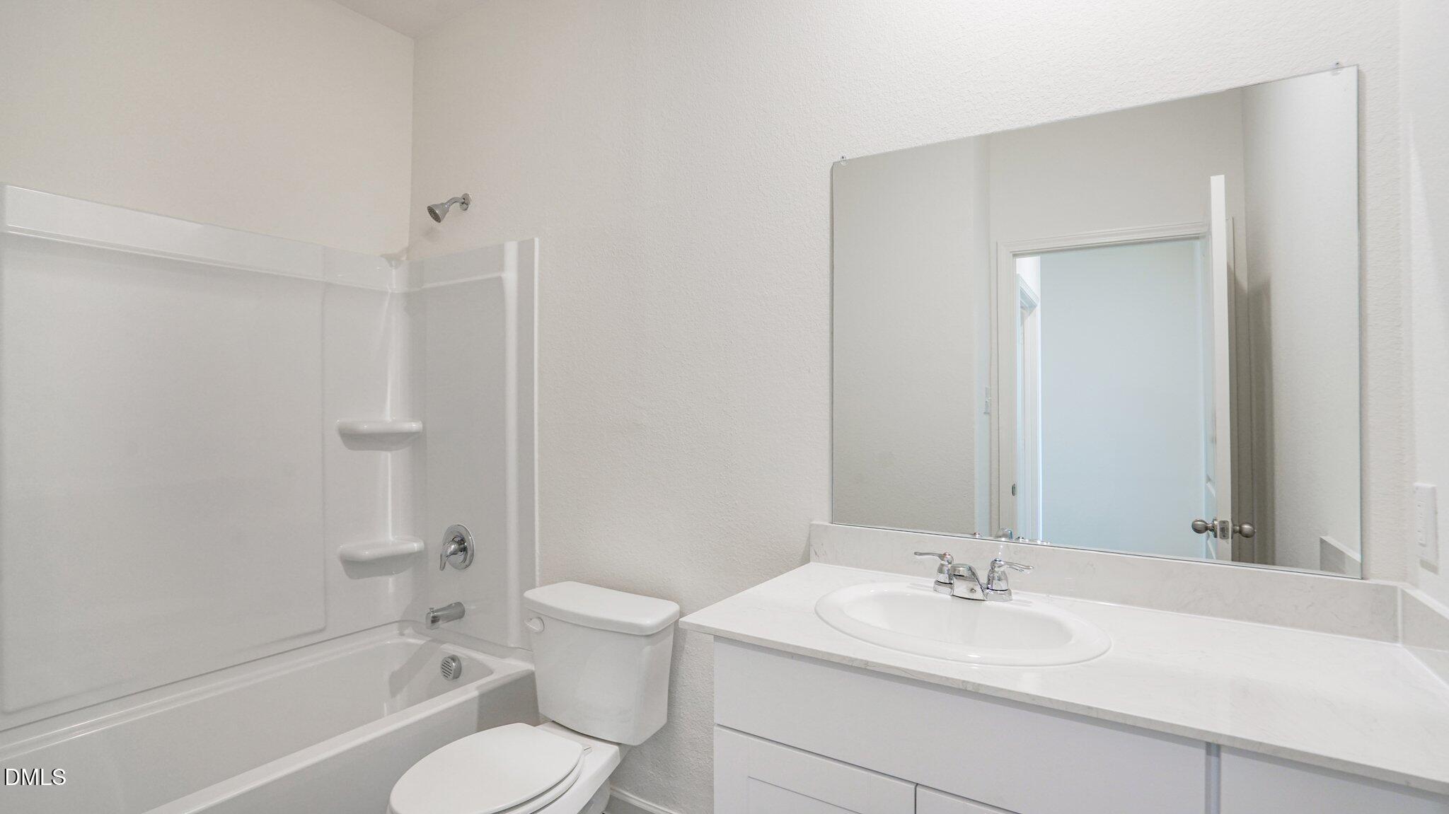 1304 Solace Way Rolesville, NC 27571 - Photo 27 of 34 a bathroom with a sink toilet tub vanity and shower