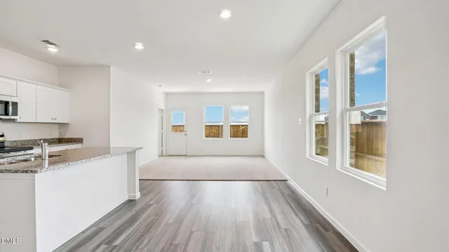 a large white kitchen with cabinets