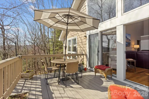 a patio with glass top table and chairs