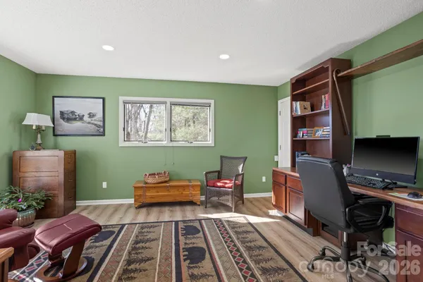 a living room with furniture and a piano