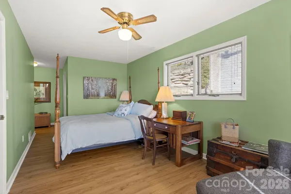 a bedroom with a bed and a desk