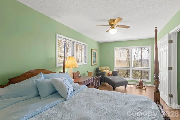 a bedroom with furniture and a large window