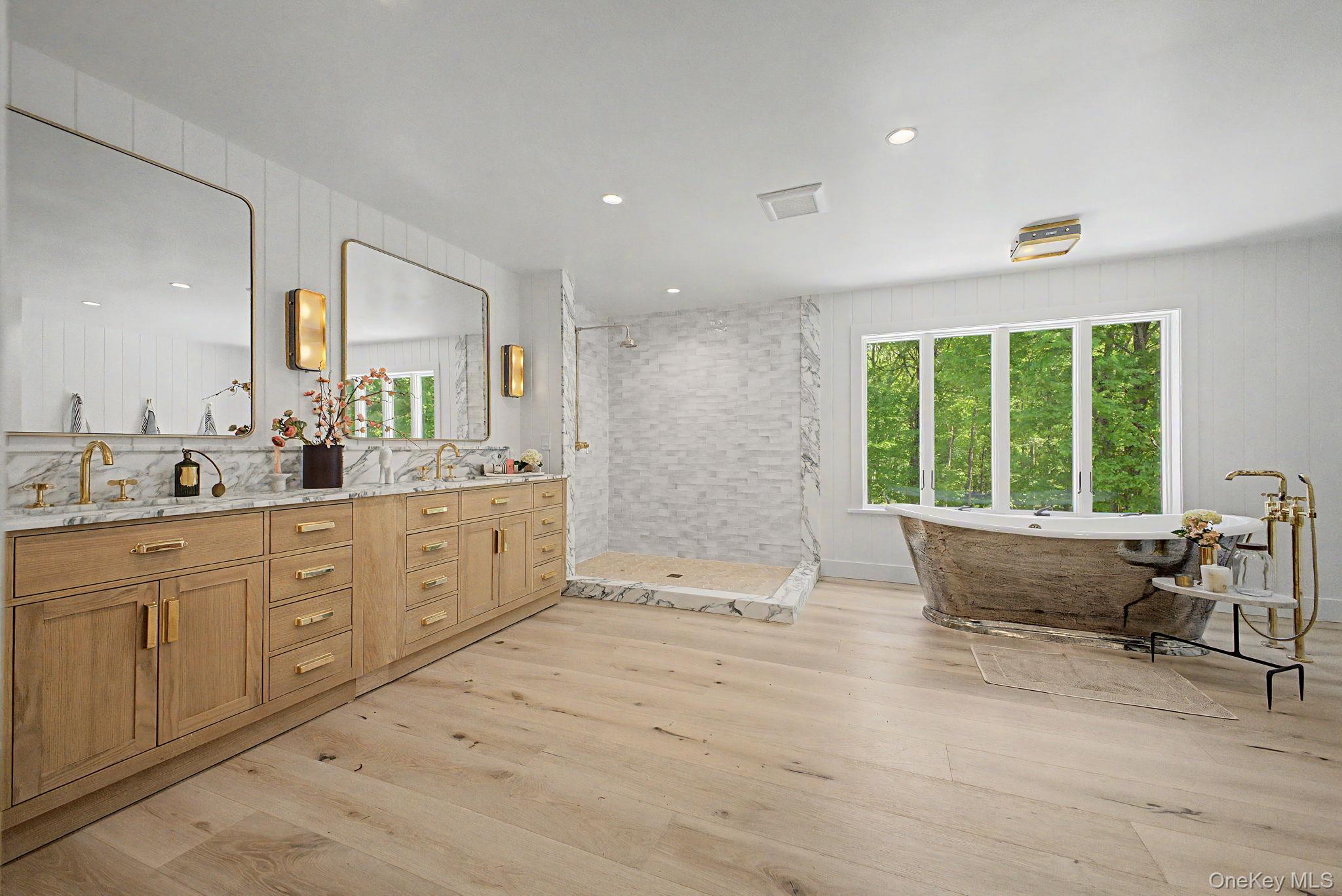 240 Eastwoods Road Pound Ridge, NY 10576 - Photo 29 of 46 a spacious bathroom with a double vanity sink large mirror and window
