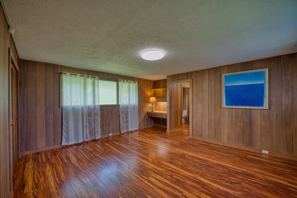 27-296 Ka'ie'ie Road Papaikou, HI 96781 - Photo 14 of 28 a view of a room with wooden floor and brick walls