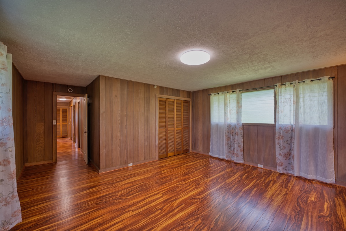 27-296 Ka'ie'ie Road Papaikou, HI 96781 - Photo 15 of 28 a view of an empty room with wooden floor and a window
