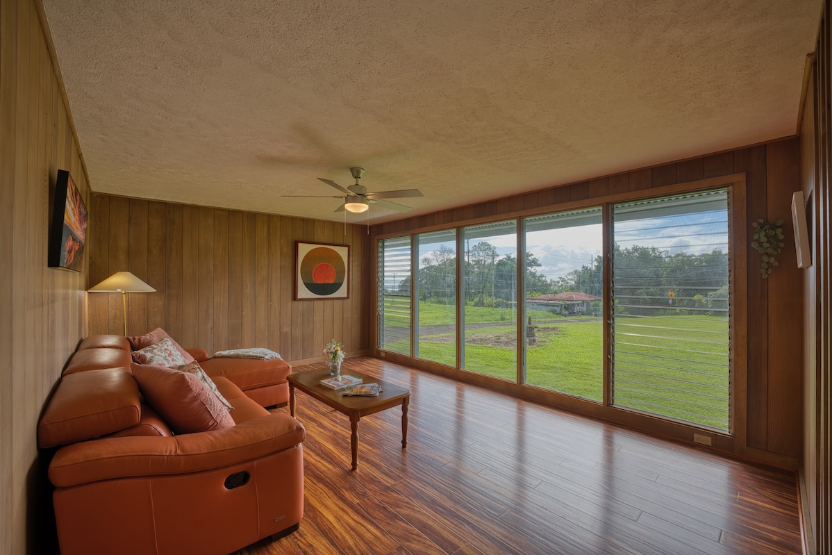 27-296 Ka'ie'ie Road Papaikou, HI 96781 - Photo 17 of 28 a living room with furniture and a floor to ceiling window
