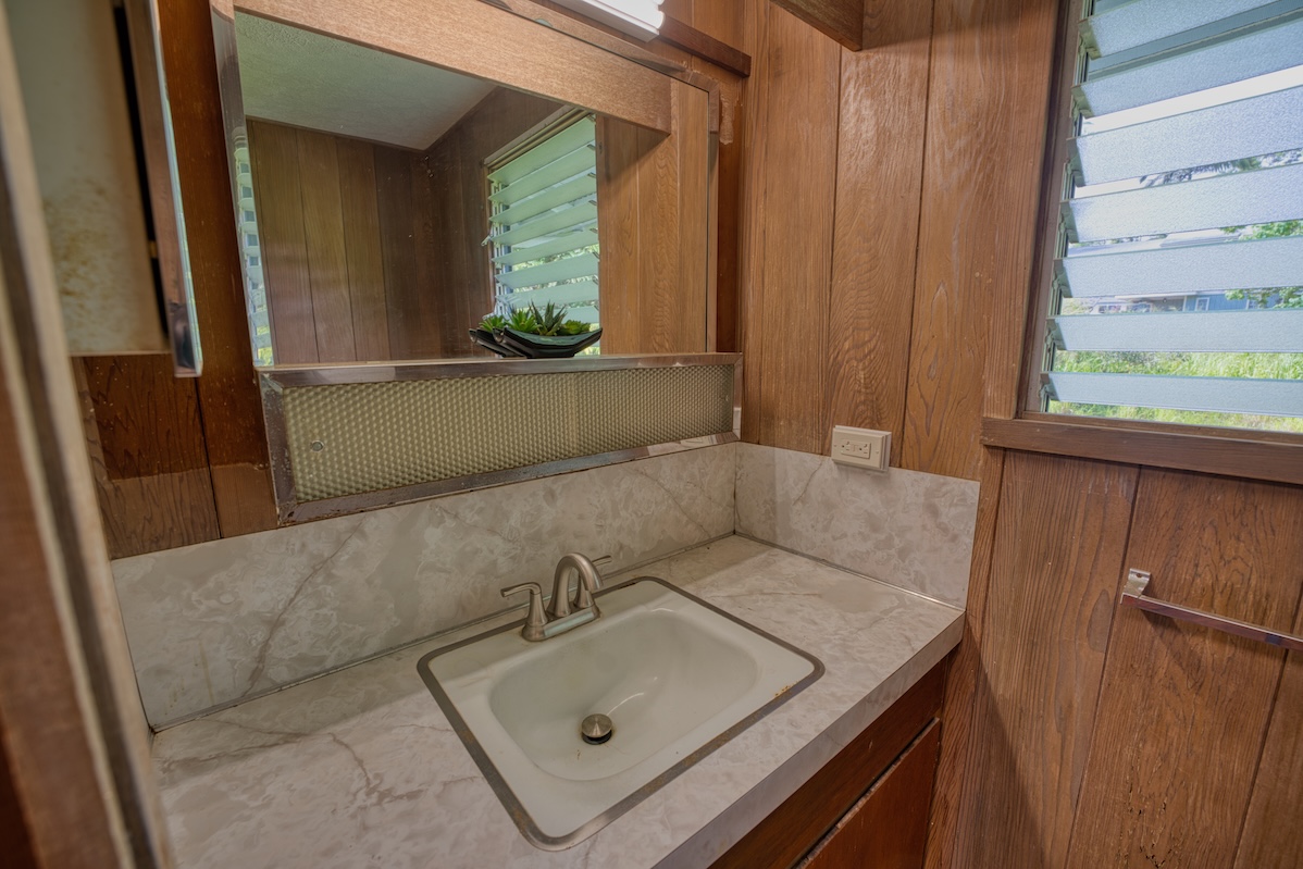 27-296 Ka'ie'ie Road Papaikou, HI 96781 - Photo 18 of 28 a bathroom with a sink and a mirror