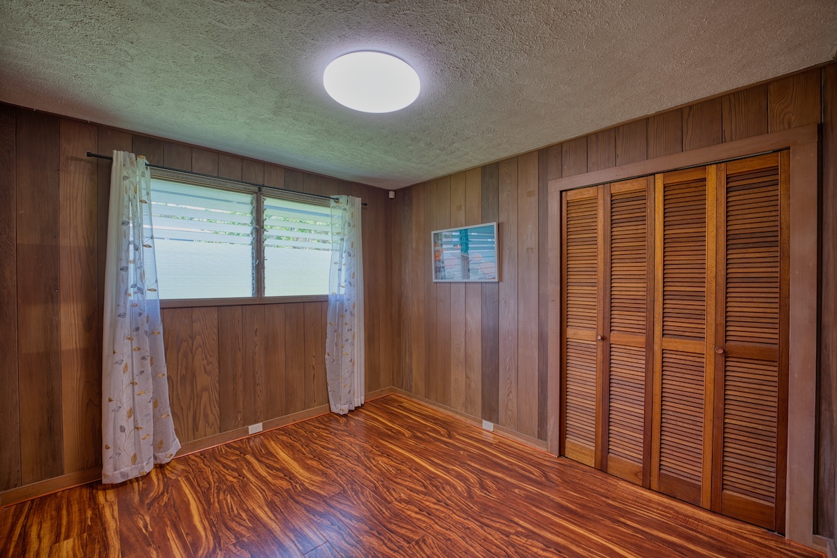 27-296 Ka'ie'ie Road Papaikou, HI 96781 - Photo 19 of 28 a view of a room with wooden floor and windows