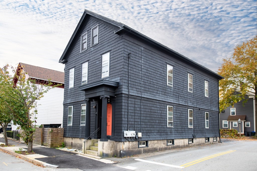 a front view of a house with a street