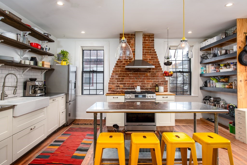 206 Smith Street Providence, RI 02908 - Photo 28 of 40 a kitchen with stainless steel appliances granite countertop a stove and cabinets