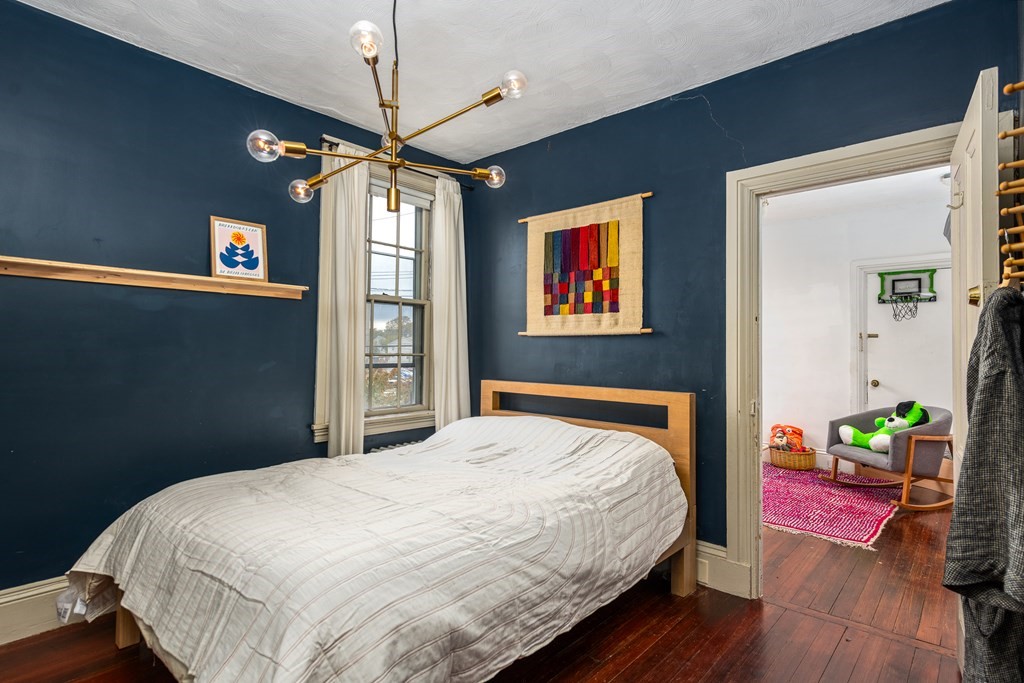 206 Smith Street Providence, RI 02908 - Photo 32 of 40 a bedroom with a bed dresser and a window