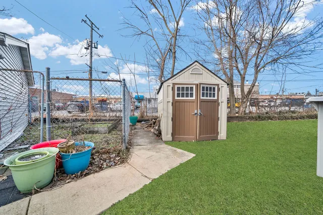 a view of a small house with yard and sitting area