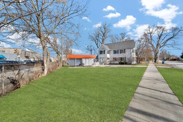 a front view of a building with a yard