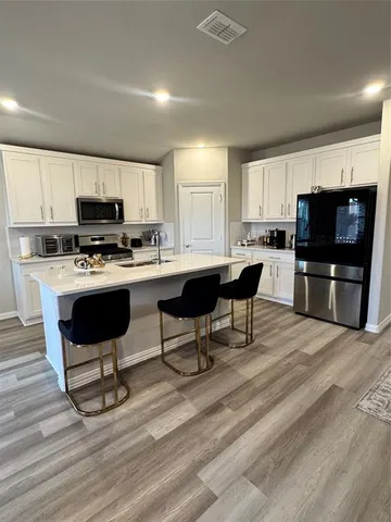 a kitchen with a stove a sink and a microwave