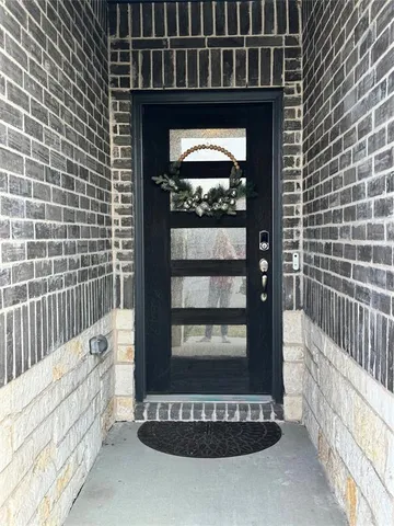 a view of a porch with a floor to ceiling window and wooden fence