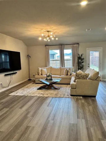 a living room with furniture and a flat screen tv