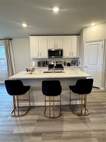 a kitchen with a dining table and chairs