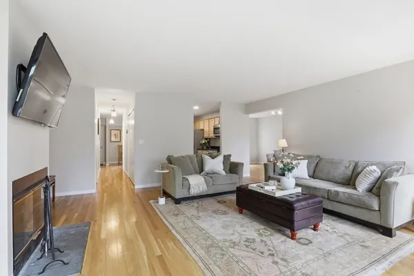 a living room with furniture a large window and a flat screen tv