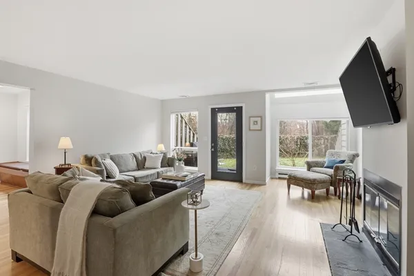 a living room with furniture a fireplace and a flat screen tv