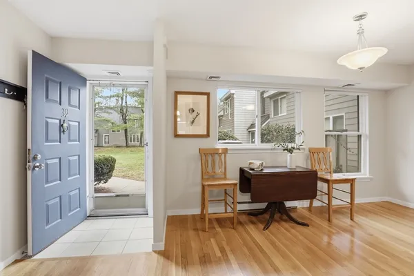 a living room with furniture and a floor to ceiling window