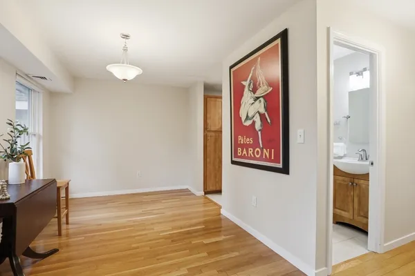a kitchen with stainless steel appliances granite countertop white cabinets a stove a microwave and a sink