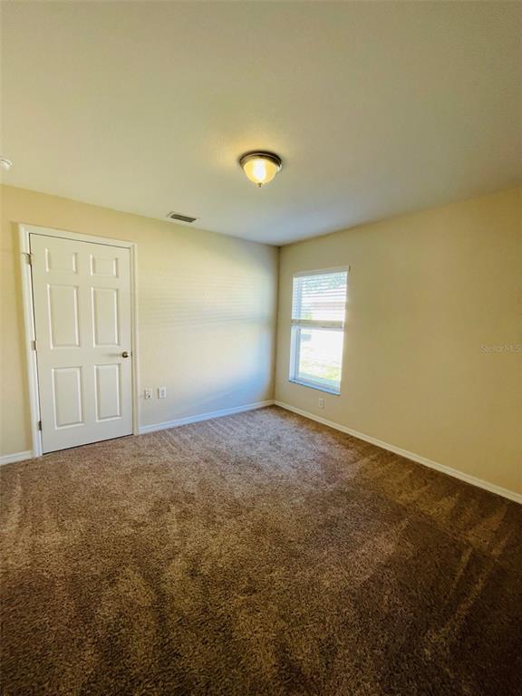 117 Angol Street Punta Gorda, FL 33983 - Photo 14 of 20 an empty room with windows and closet