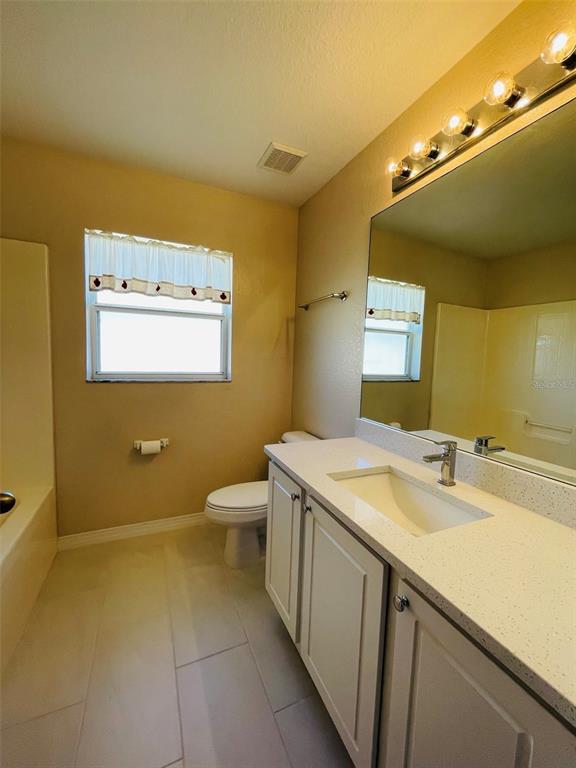 117 Angol Street Punta Gorda, FL 33983 - Photo 16 of 20 a bathroom with a granite countertop sink and a mirror