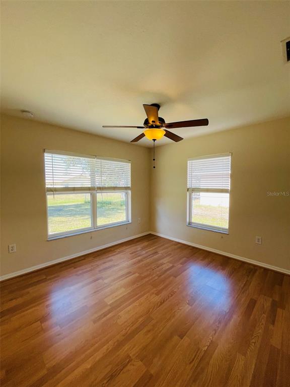 117 Angol Street Punta Gorda, FL 33983 - Photo 17 of 20 a view of empty room with wooden floor and fan