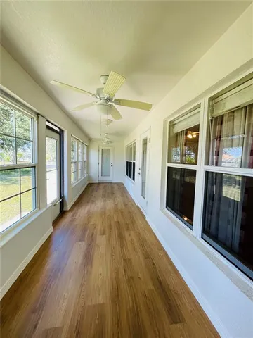 a view of a house with wooden floor and balcony
