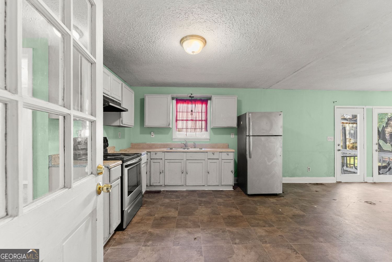 2346 4th Street Gainesville, GA 30504 - Photo 3 of 36 a kitchen with refrigerator and cabinets