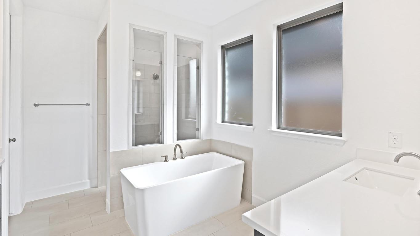 444 Prickly Poppy Loop Kyle, TX 78640 - Photo 11 of 40 Bathroom featuring vanity, a stall shower, light tile patterned flooring, and a freestanding tub