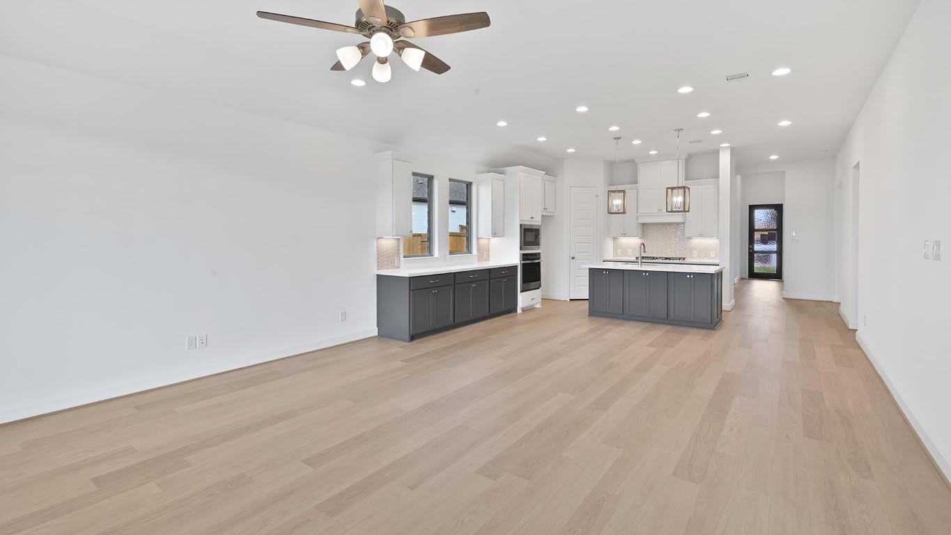 444 Prickly Poppy Loop Kyle, TX 78640 - Photo 40 of 40 Kitchen featuring open floor plan, light countertops, recessed lighting, light wood-type flooring, and a center island with sink