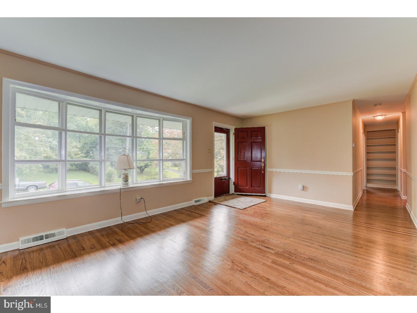 55 Home Road Hatboro, PA 19040 - Photo 3 of 23 a view of an empty room with wooden floor and a window