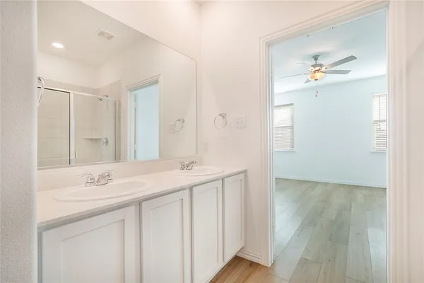 a bathroom with a glass shower door