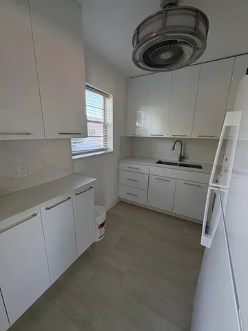 a kitchen with stainless steel appliances a sink a stove and cabinets