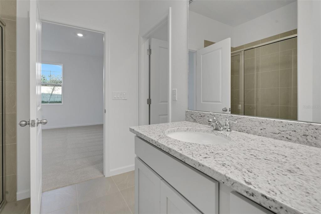 2824 Doolittle Street Tavares, FL 32778 - Photo 11 of 32 a bathroom with a granite countertop sink and a mirror