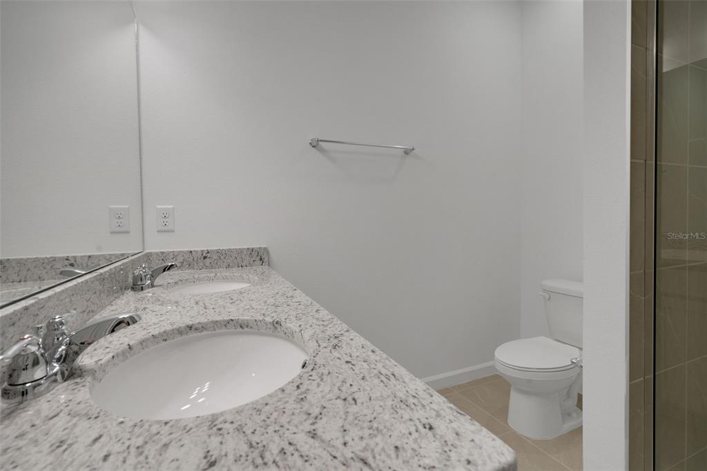 2824 Doolittle Street Tavares, FL 32778 - Photo 12 of 32 a bathroom with a sink a toilet and a mirror